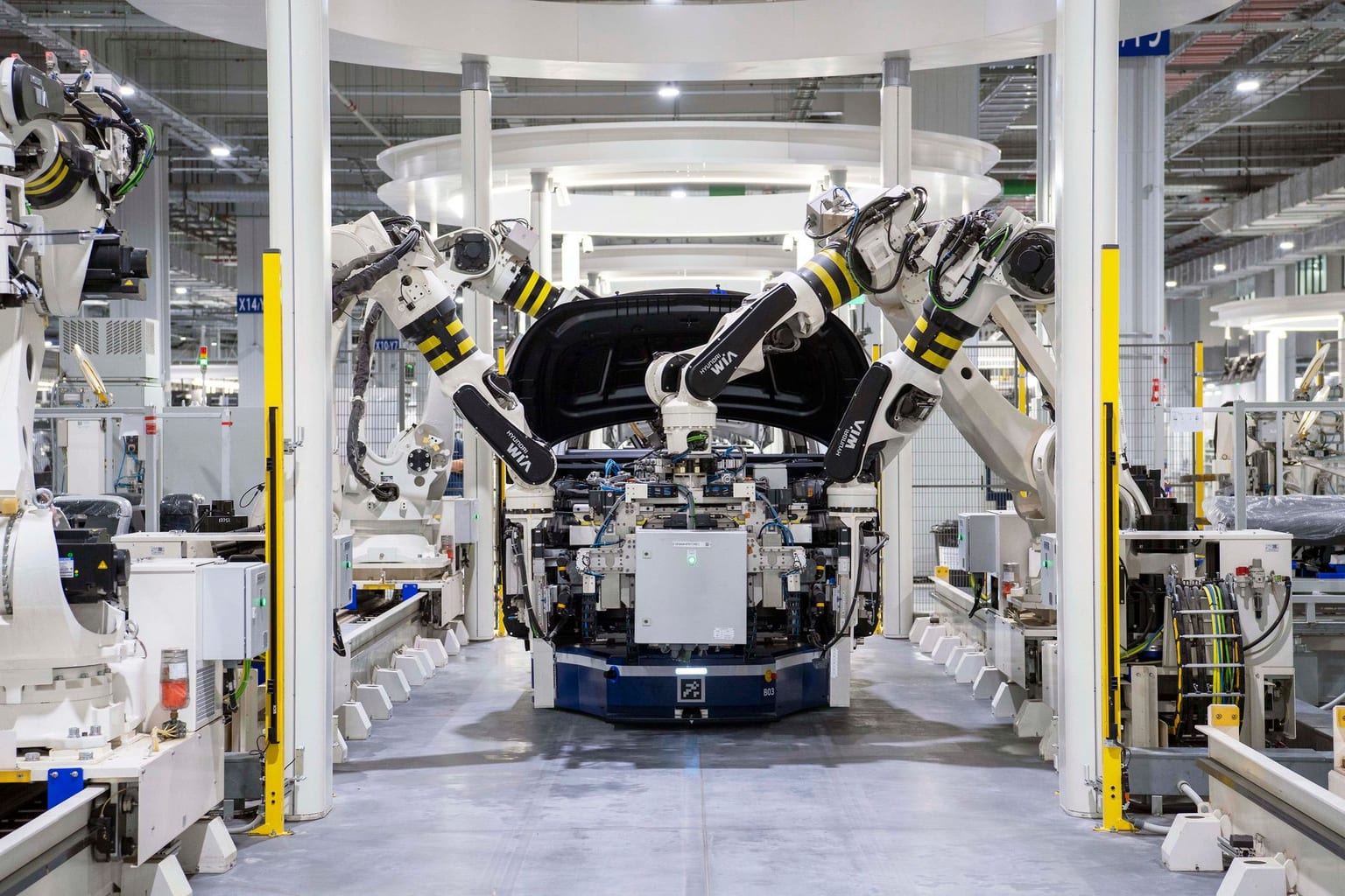 Robots assembling a car in a modern factory.